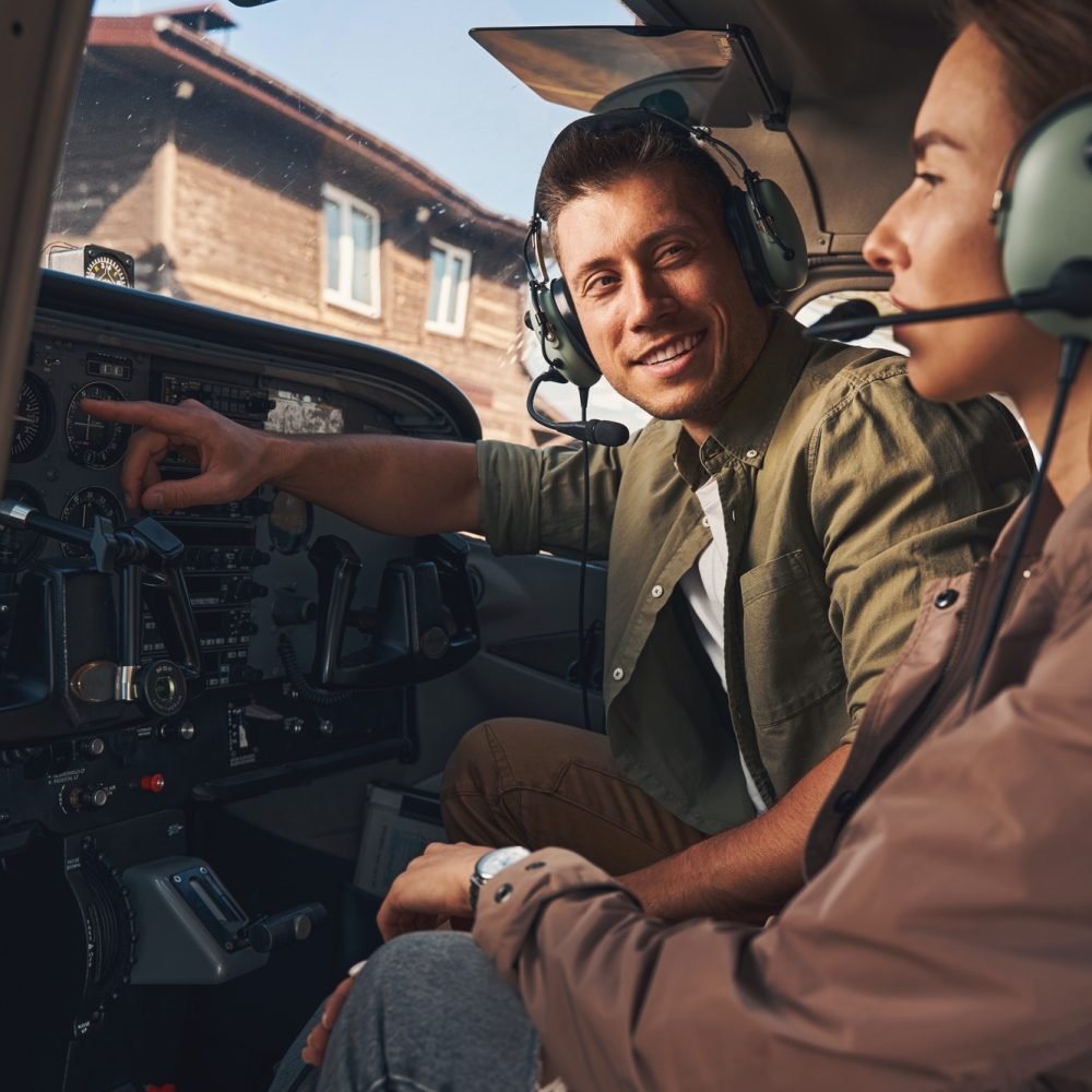 cheerful-young-man-giving-flight-lesson-to-woman.jpg cheerful-young-man-giving-flight-lesson-to-woman.jpg